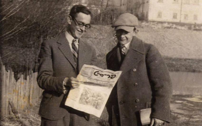 Two men reading the paper of Frayhayt, a youth organization, Zamosc, Poland, 1934.