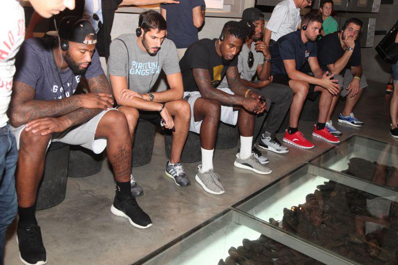 The players contemplate the collection of victims' shoes