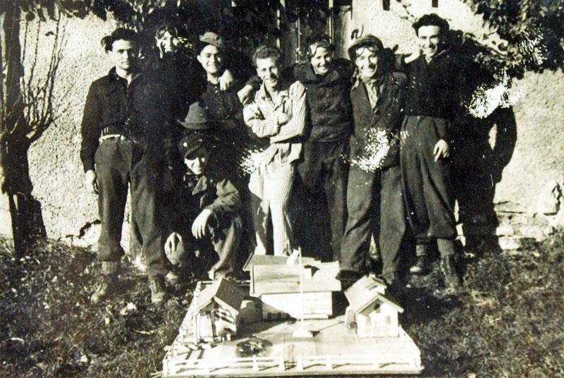 Some of the kibbutz members with the model of the Firstbach farm 