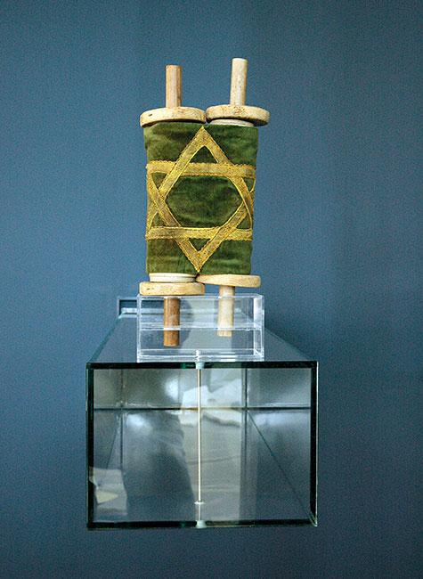 A small Torah scroll and mantle, Czernowitz, Romania. Jews deported to Transnistria returned with it to Czernowitz