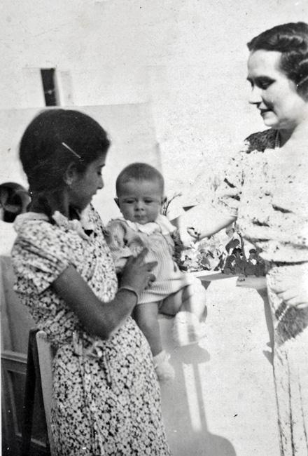 Zmira as a child in Libya, with the baby that she cared for