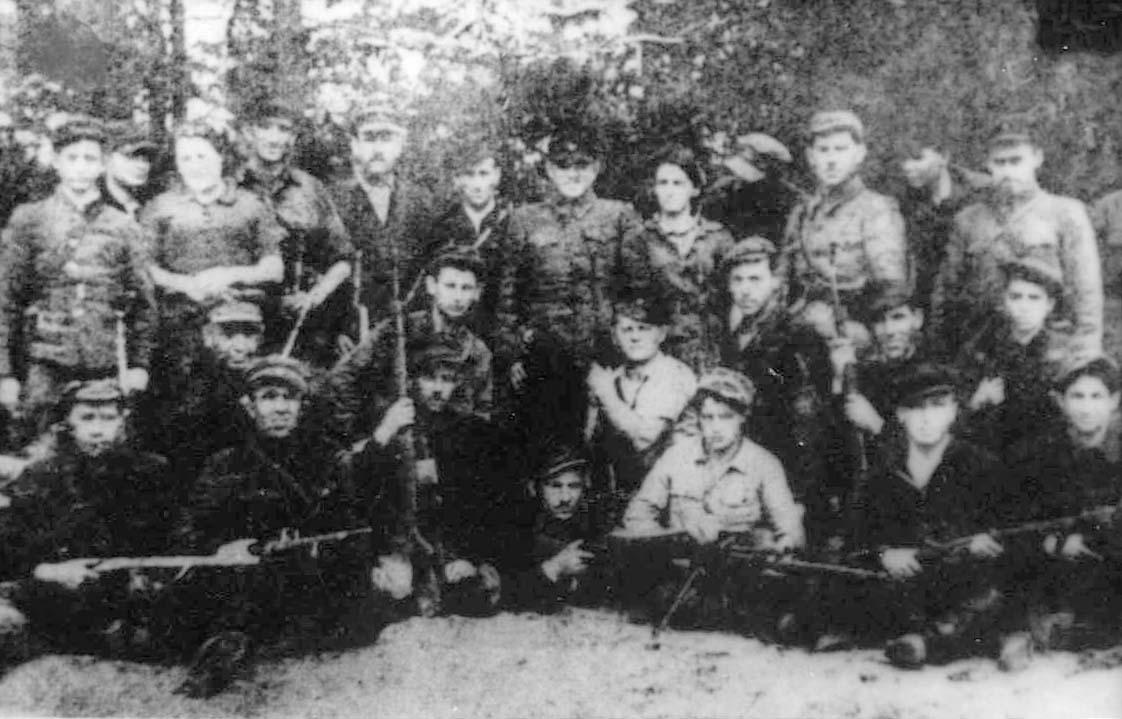 Guard of Jewish partisans at the airport in the Naliboki Forest. Among the group are a number of ex-Mir residents – : Zeev (Welwel) Schreiber (standing far left), Moshe Breslin (standing seventh from left)