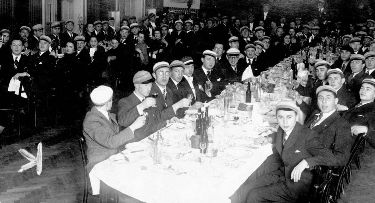 Yeshiva students giving a toast during a meal. Vilna, prewar