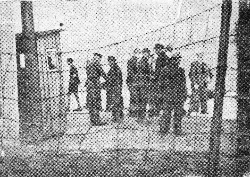 The entrance to the ghetto (newspaper cutting). The caption reads, &quot;By the ghetto gate everyone is inspected and their clothes are searched&quot;.