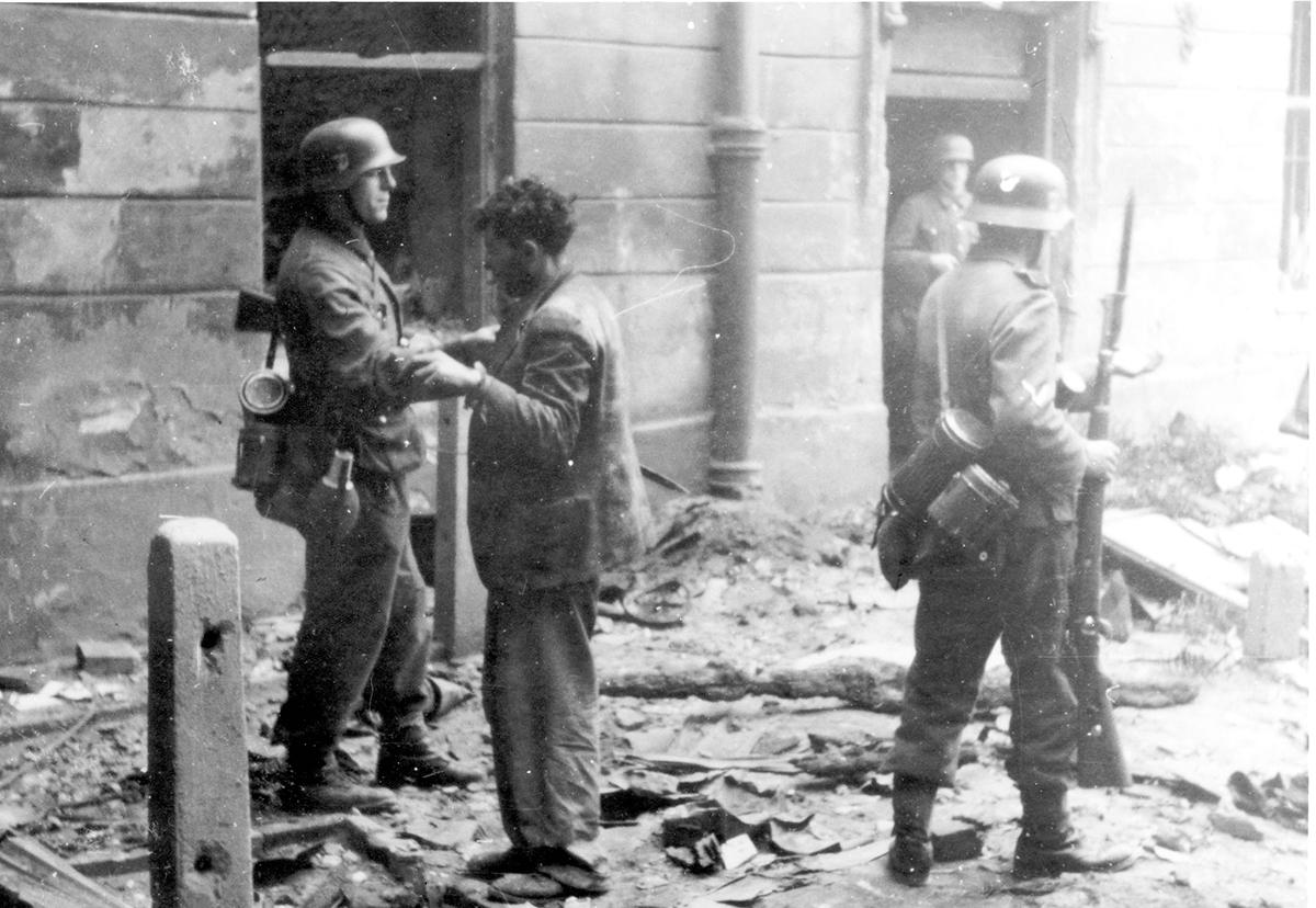 Waffen SS soldiers with a Jew who was captured during the Warsaw Ghetto Uprising