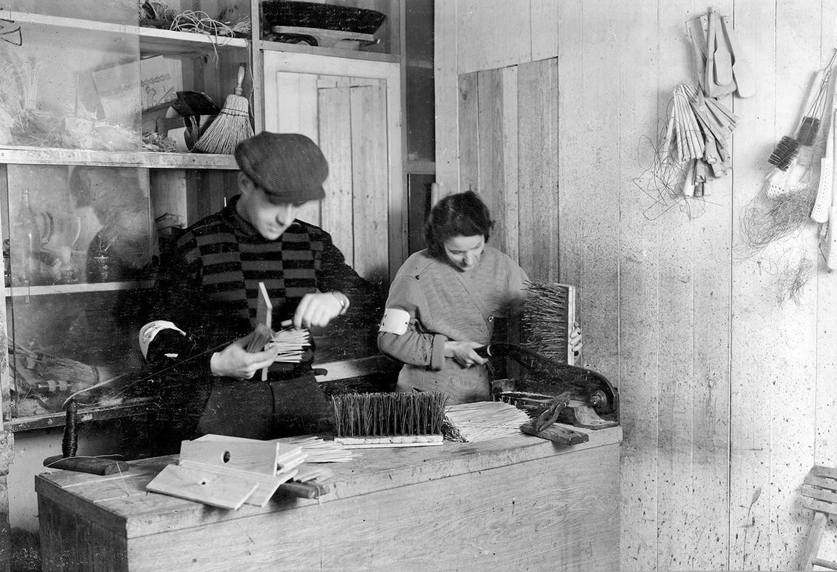 Jews working in a brushes and brooms workshop at 17 Solna St., Warsaw ghetto
