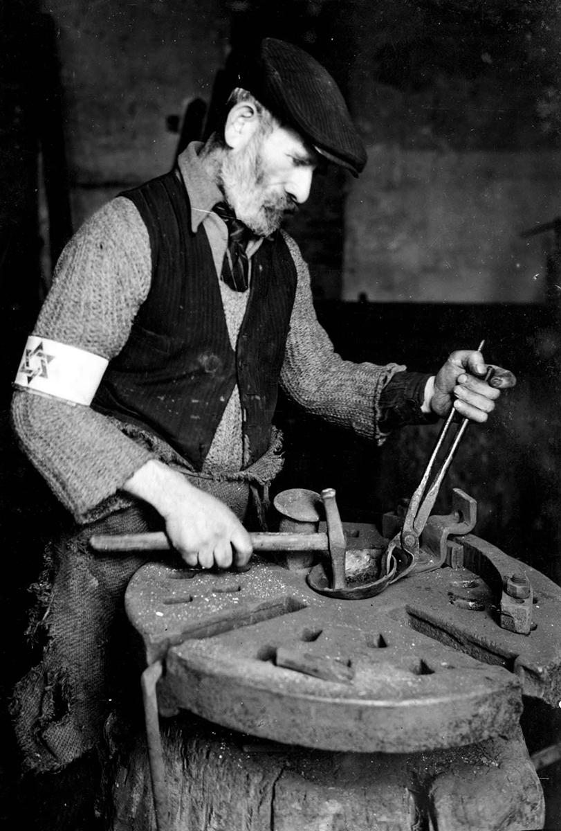 Jewish man working in a metal workshop, Warsaw ghetto