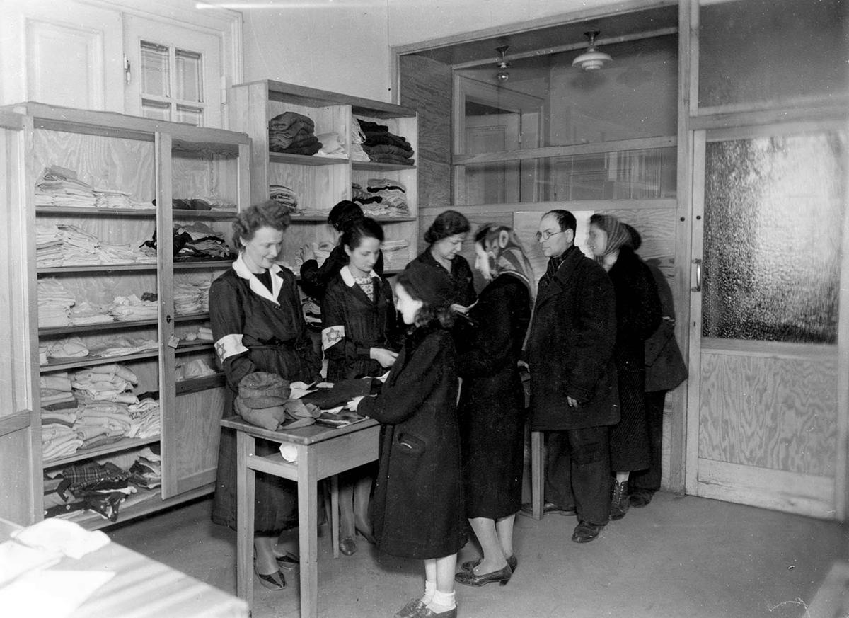 Preparing to distribute clothing to the needy at the main warehouse of the ZSS at 13 Leszno St., Warsaw ghetto