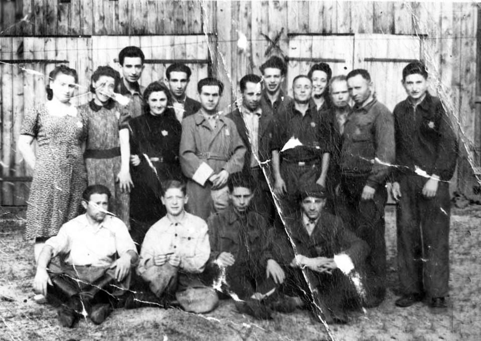 Shabtai Shepsel Prushan (seated second from the right) with other factory workers, in Vilna, probably in the ghetto