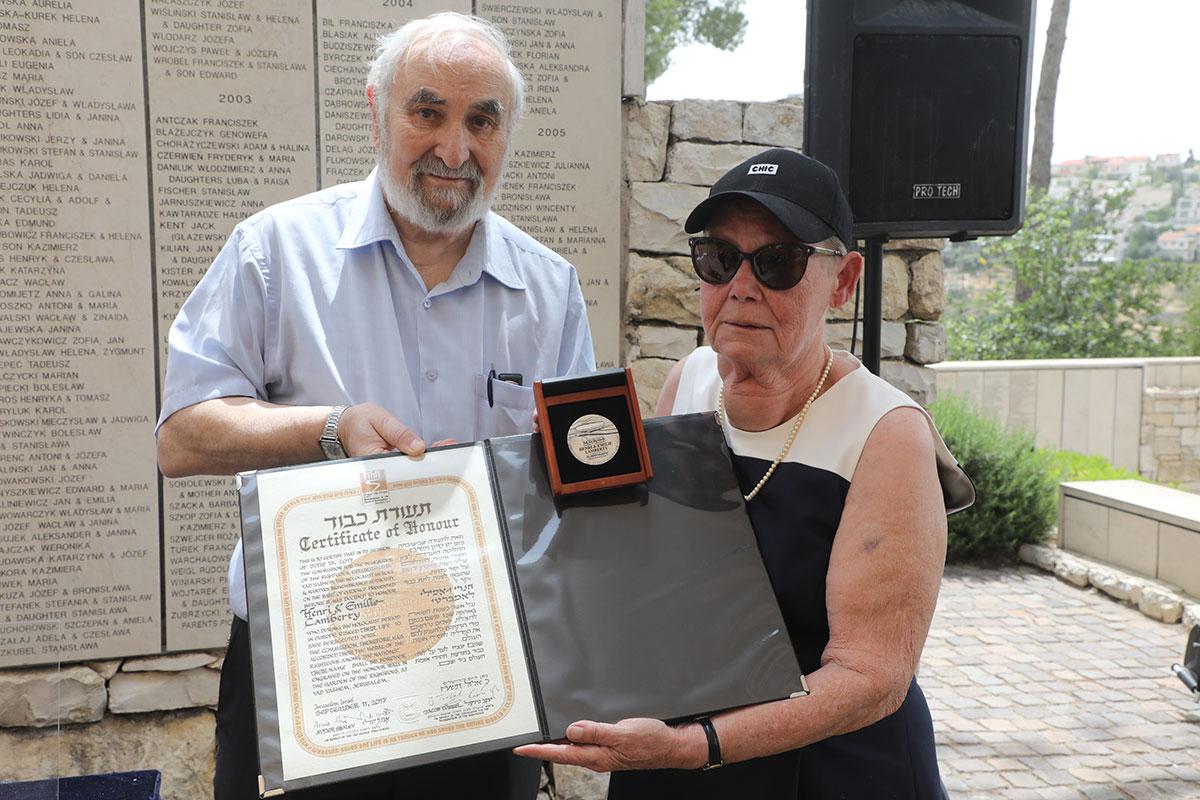 Jacqueline Lamberty receiving the certificate and medal of honor on behalf of her late parents, Righteous Among the Nations Henri and Emilie Lamberty, from Righteous Commission Delegation member Jacky Offen