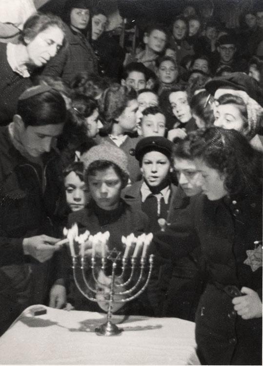 A Hanukkah candle lighting ceremony in the Westerbork transit camp, Netherlands, December 1943