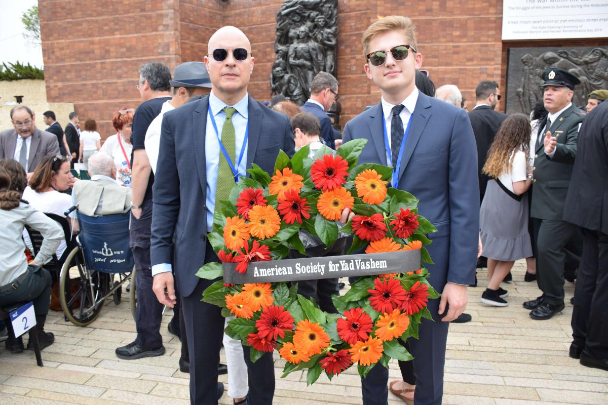 Mark Moskowitz and Jonah Burian laying a wreath at Yad Vashem's Wreath Laying Ceremony in the Warsaw Ghetto Square on Holocaust Remembrance Day