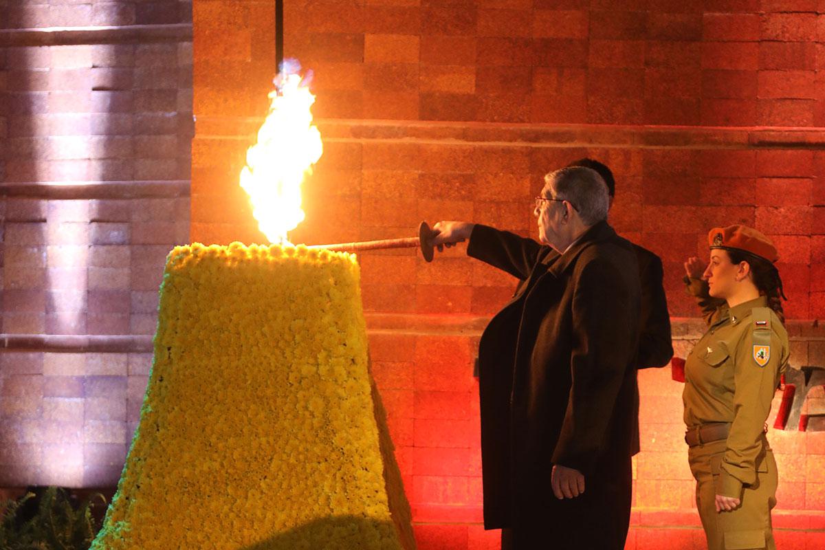 Avner Shalev, Chairman of the Yad Vashem Directorate lights the Memorial Torch at the beginning of the ceremony