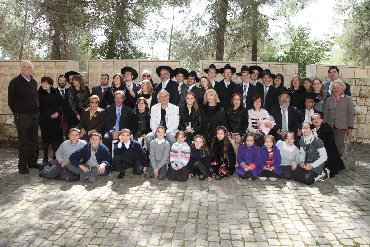 Survivor Claire Kohlman with her children, grandchildren and great grandchildren and with Serge Maringnan, grandson of Righteous Among the Nations Jeanne Albouy, Garden of the Righteous, Yad Vashem, 4 March 2013