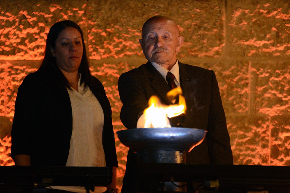 Holocaust survivor Ephraim Reichenberg lights one of the six torches at the ceremony