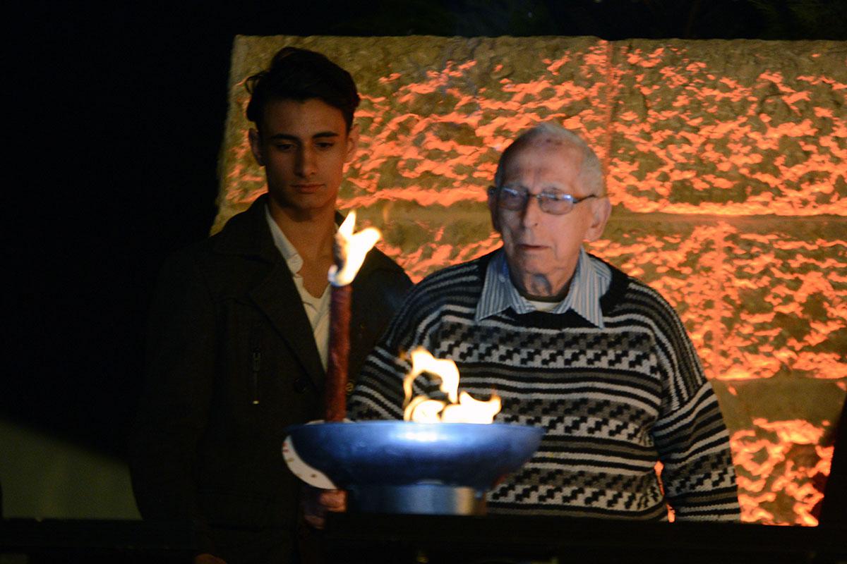 Holocaust survivor Eggi Lewysohn lights one of the six torches at the ceremony