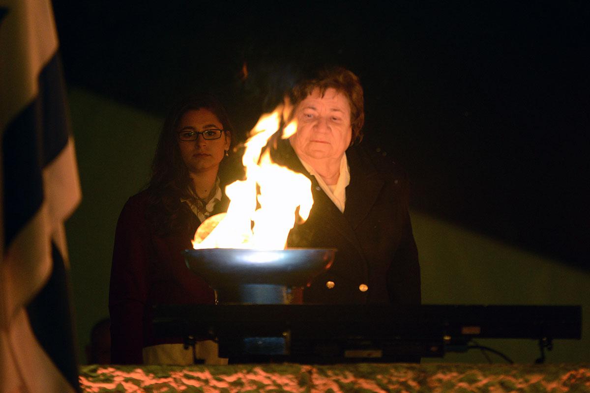 Holocaust survivor Shela Altaraz lights one of the six torches at the ceremony
