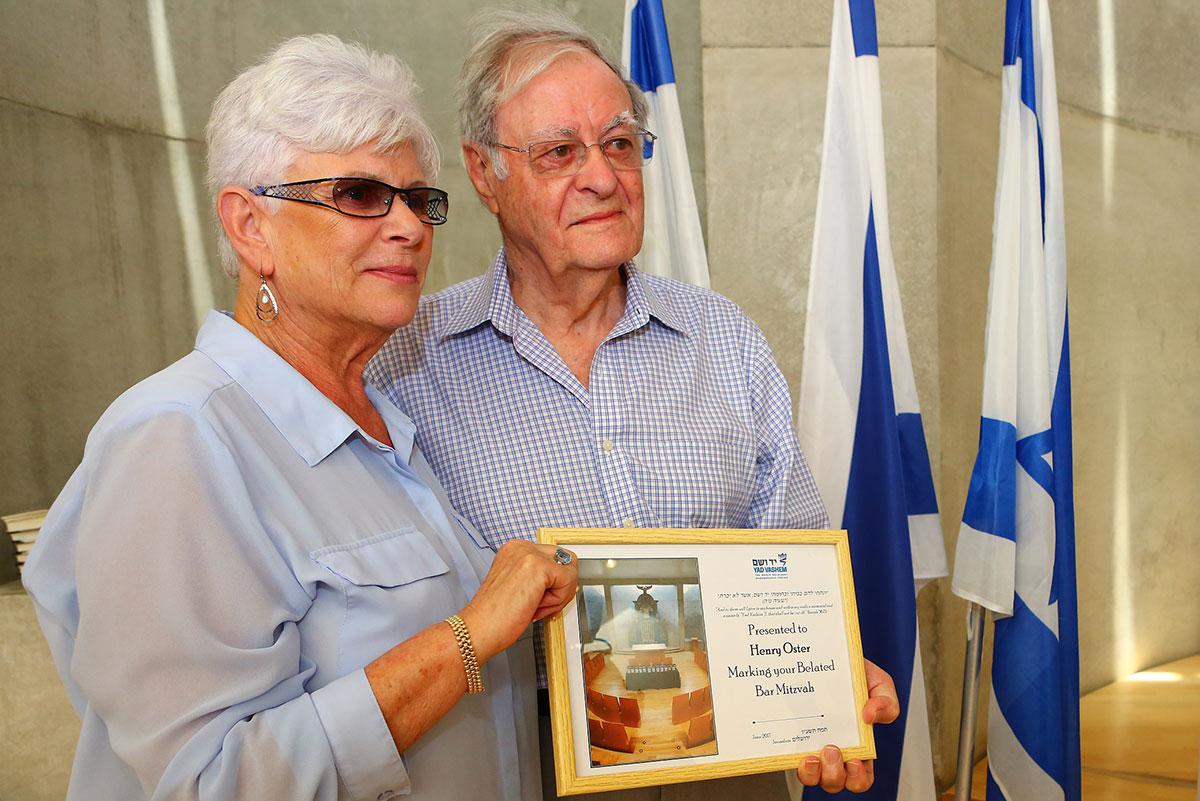Henry Oster accepting his bar mitzvah certificate with his wife, Sara at the Yad Vashem synagogue