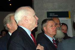 Senators John McCain (forefront) and Lindsey Graham study an exhibit in the Holocaust History Museum