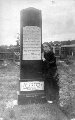 Miriam Eisenberg née Eilenberg standing by her mother Chava's grave