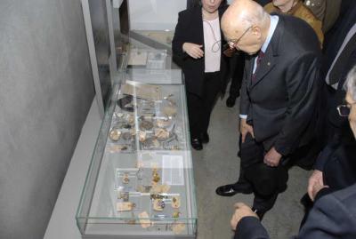 President Napolitano studies an exhibit in the Holocaust History Museum of objects taken from the Jews in Trieste before their deportation to the concentration camps