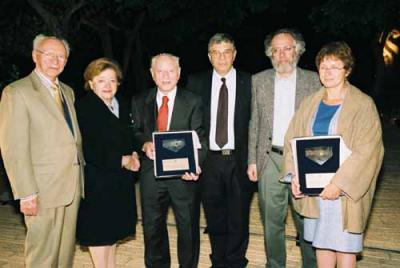 Sam and Gladys Halpern and George and Bella Savran (representing her parents Eva and Arie Halpern) are presented with plaque of recognition by Avner Shalev, Chairman of the Yad Vashem Directorate. Also pictured (left) is Eli Zborowski, Chairman of the Ame