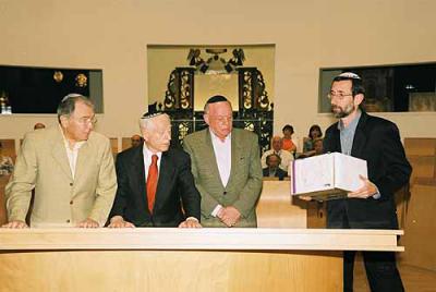 Sam Halpern (center) gives 1500 Pages of Testimony that were collected in the United States to Alex Avraham, Director of the Hall of Names (right). Sam Halpern is flanked on his right by Marc Palmer and on his left by William Mandel. The ceremony took pla