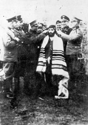 An Orthodox Jew being abused by Nazis in Kozienice, Poland, September 1939