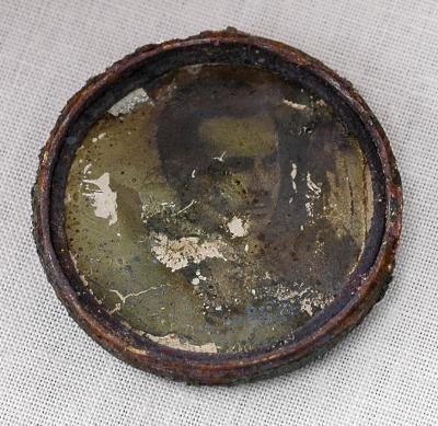 Pendant with two photographs found in a killing pit on the outskirts of Nyteshin, Ukraine