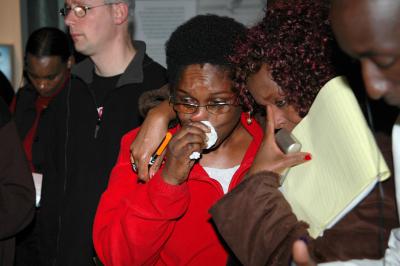 Yolande Mukagasana wipes away a tear during a tour of the new Museum at Yad Vashem