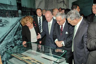 The Polish President (second from right) looks at the Auschwitz Album during his tour of the Holocaust History Museum