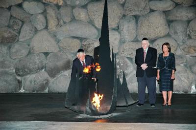 נשיא פולין מעלה את אש התמיד במהלך טקס אזכרה באהל יזכור. מאחור רעייתו ויו&quot;ר מועצת יד ושם, יוסף (טומי) לפיד