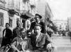 Jan Kostanski (left) and Jakob Wierzbicki ride in a rickshaw on a street in the Warsaw ghetto. (United States Holocaust Memorial Museum)