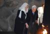 David Feuerstein, survivor of Auschwitz, accompanied by his daughter Helena Gaon Feuerstein, rekindles the eternal flame in the Hall of Remembrance
