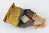 A cloth bag containing soap, a sponge, a toothbrush, a button and a tiny piece of lipstick wrapped in paper