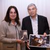 Avner Shalev and Rona Ramon with a copy of Petr Ginz's "Moon Landscape." and a photograph of Ilan Ramon before his doomed space mission