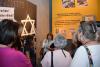 Debby Spero explaining an exhibit during the tour in the Holocaust History Museum