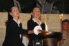 Twins Iudit Barnea and Lia Huber (nées Csengeri) light one of the six torches at the ceremony
