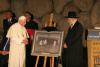 Chairman of the Yad Vashem Council, Rabbi Israel Meir Lau presents a gift to Pope Benedict XVI.
