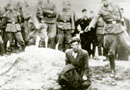 Vinnitsa, Ukraine. A German soldier shoots a Jew above a mass grave, probably 1941