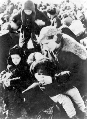 Lubny, Ukraine. A mother with her two children at the assembly point awaiting, with other Jews from the town, their execution, October 16, 1941