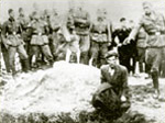 Vinnitsa, Ukraine, A German soldier shooting a Jew atop a mass grave, 1943.