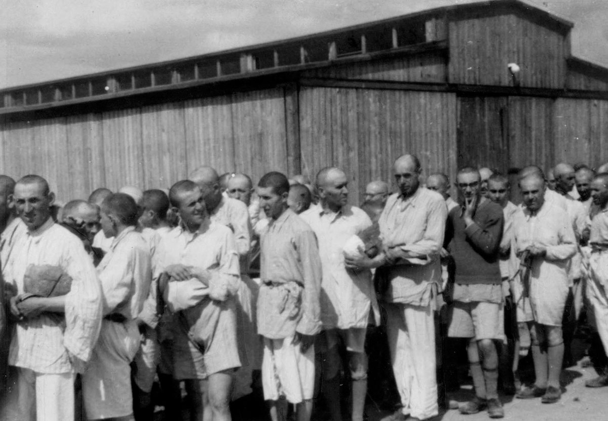 Young Jewish men after the shower leave the washing barracks. Their hair was shaved and they were given prison uniforms