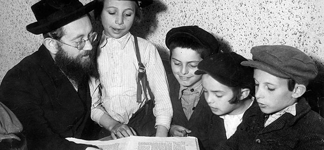 A teacher and his students studying the Talmud, Poland, prewar