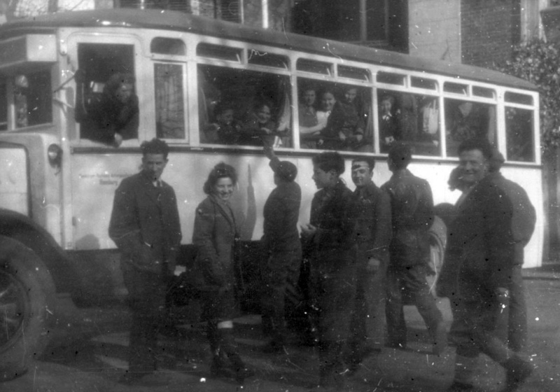 Children leaving the children's home in Blankenese by bus, on their way to Marseille port accompanied by Jewish Brigade soldiers. Hamburg, Germany 1946