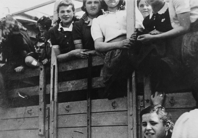 Group of children on a Jewish Brigade truck on their way from the Bergen-Belsen DP camp to the Blankenese children's home in Hamburg, Germany, January 1946