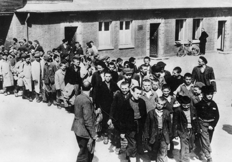 Group of "Buchenwald boys" leaving the camp accompanied by US soldiers, on their way to the train that will take them to France.  Buchenwald, Germany, June 1945
