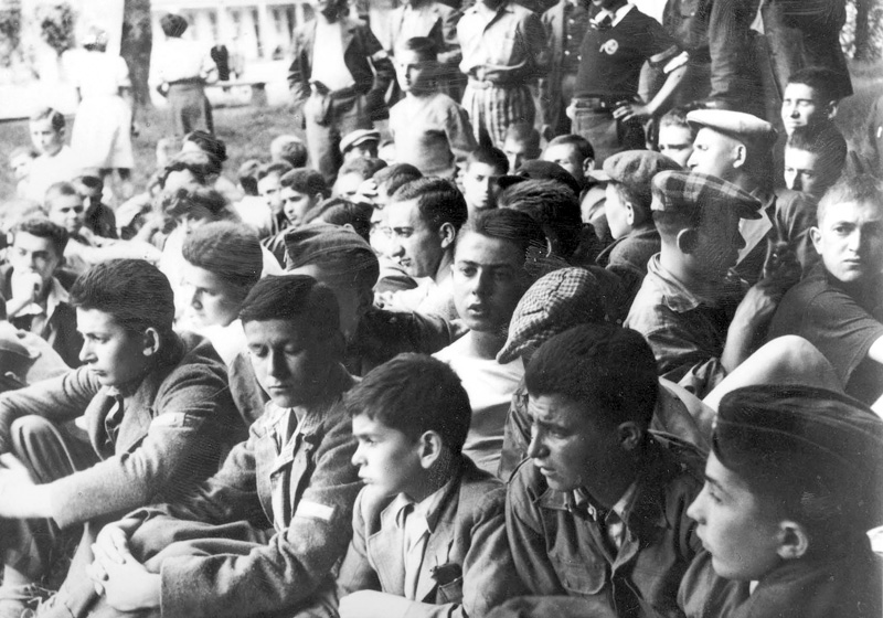 "Buchenwald boys" sitting on the grass at the children's home in Écouis, France, summer 1945