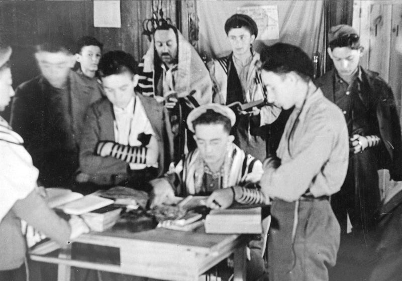 Group of "Buchenwald boys" laying tefillin (phylacteries) and praying at the children's home in Ambloy, France, 1945