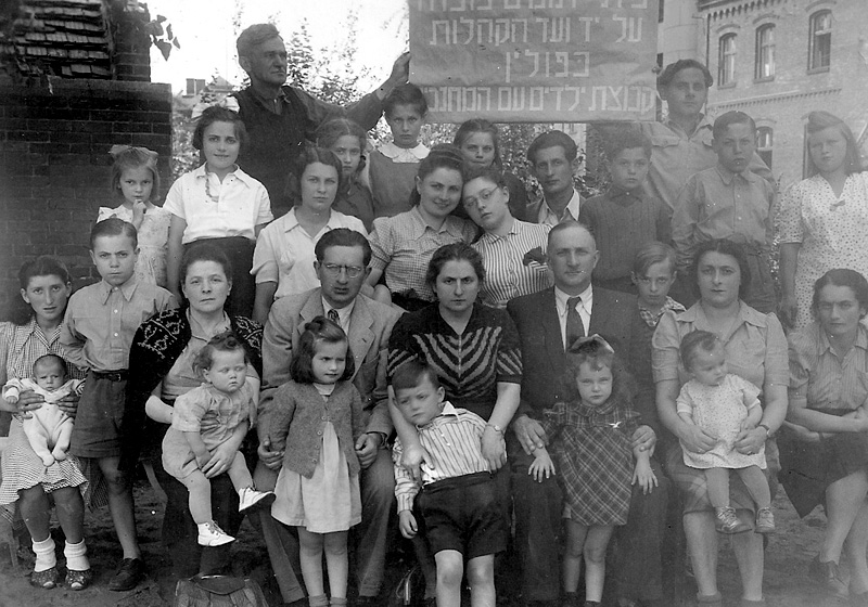 Dr. Nechama Geller, Director of the children's home in Zabrze (seated center), together with the children and staff in front of the children's home. Zabrze, Poland, postwar
